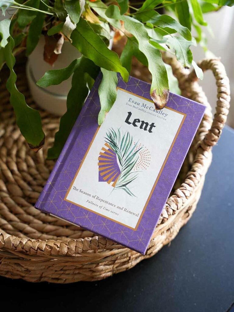 Lent book placed on a wicker basket next to a plant